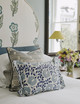 Firmdale Hotel bedroom featuring Indigo Punch Paisley pleated cushion paired with Loom Weave Indigo cushion. A fresh interior scheme of blue and yellow adds brightness and contemporary charm.